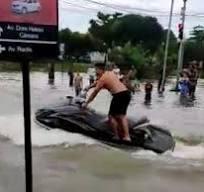 Assista: homem é flagrado pilotando jet ski em rua alagada por temporal em Goiânia